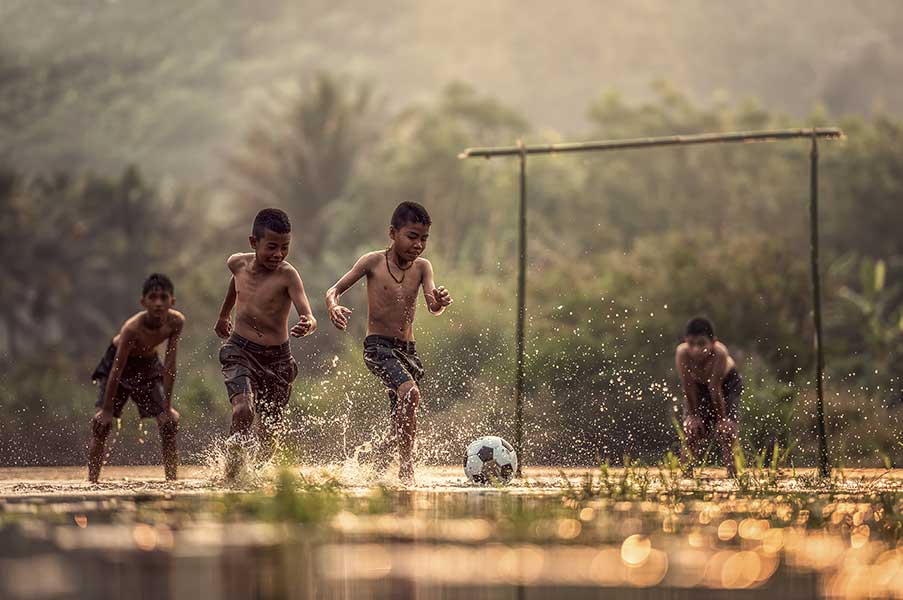 Boy kicking soccer ball